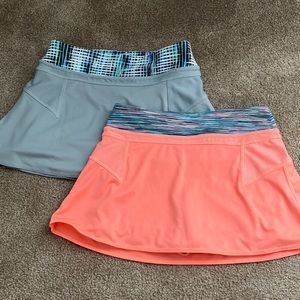 Two athleta girl skorts one in grey and one in bright coral